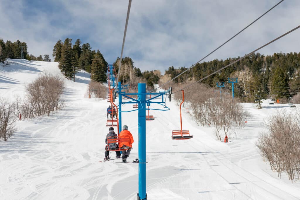 two people on a chairlift at Sandia  PEak Ski Resort