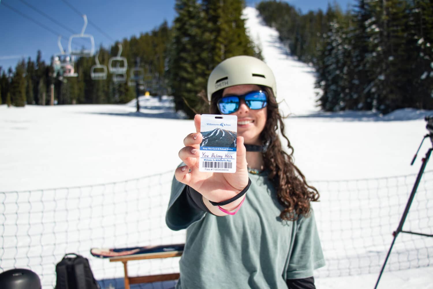 Snowboarder with a lift ticket that says You Belong Here for the 25/26 Power Pass launch