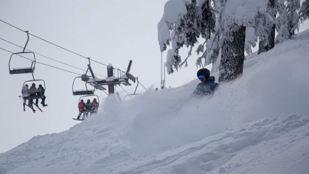 Willamette Pass Ski Resort with a snowboarder and Peak 2 Lift in the back