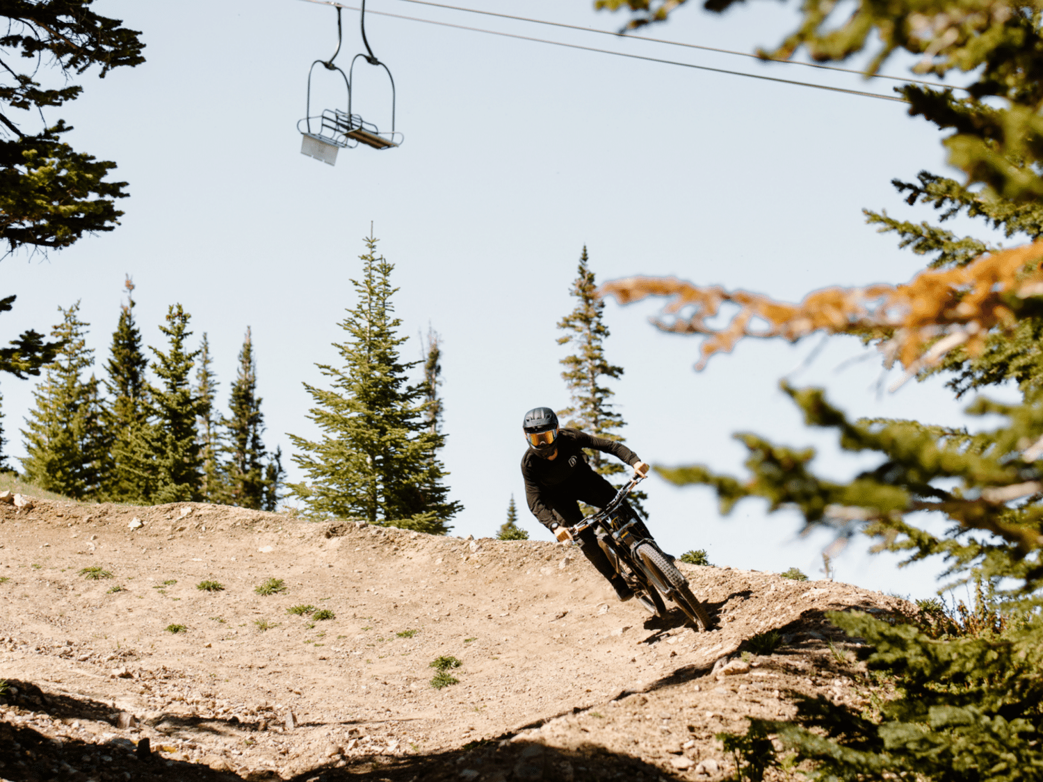 A man riding a bike on a dirt trail.