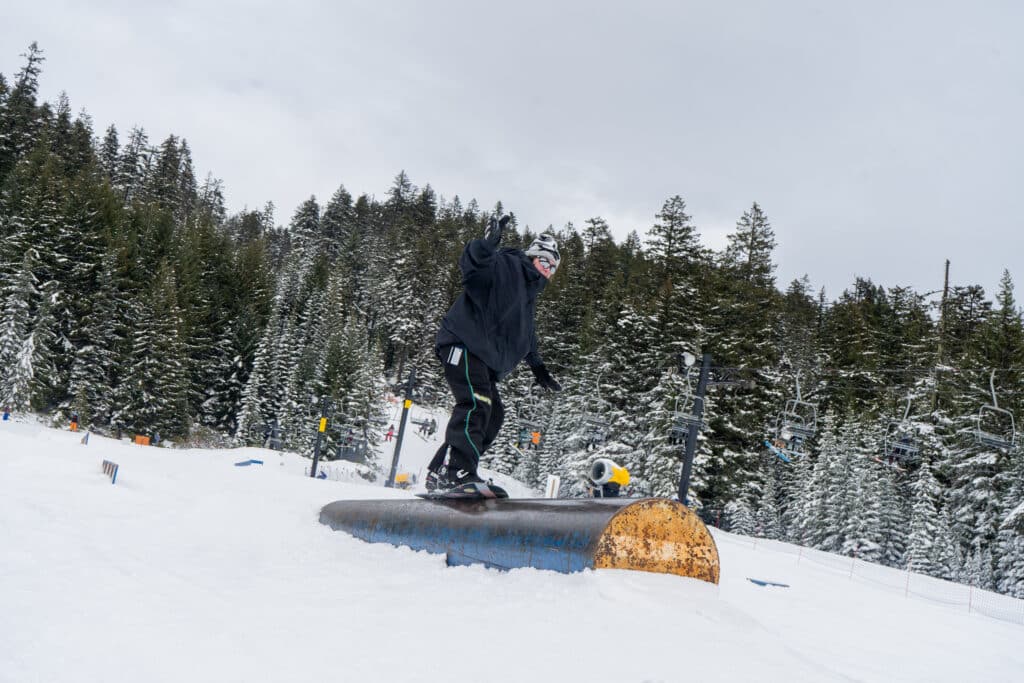 A person riding across a tube feature in a terrain park